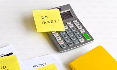 a calculator with sticky notes on it